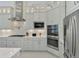 Gourmet kitchen featuring stainless steel appliances, custom cabinets, gas cooktop and decorative backsplash at 9048 Luna Ln, Sarasota, FL 34241