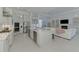 Open kitchen with stainless appliances, an island with seating, and a seamless view to the living room at 9048 Luna Ln, Sarasota, FL 34241
