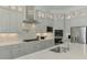Modern kitchen with stainless steel appliances, granite countertops, decorative tile backsplash, and custom cabinets at 9048 Luna Ln, Sarasota, FL 34241