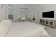 Spacious main bedroom featuring a comfortable seating area and large television at 9048 Luna Ln, Sarasota, FL 34241
