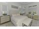 Bright main bedroom features a sitting area, tray ceiling and views of backyard pool at 9048 Luna Ln, Sarasota, FL 34241