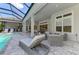 Inviting outdoor living space with a pool, spa, lounge chairs, and a fully equipped outdoor kitchen area at 9048 Luna Ln, Sarasota, FL 34241