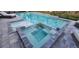 Inviting pool and spa combination with stylish tile and stone work, perfect for relaxation and entertainment at 9048 Luna Ln, Sarasota, FL 34241