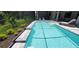 Refreshing pool with clear blue water, surrounded by lush greenery, and offering a private backyard oasis at 9048 Luna Ln, Sarasota, FL 34241
