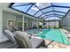 Relaxing outdoor living area with a pool, spa, comfortable lounge chairs and a screened enclosure at 9048 Luna Ln, Sarasota, FL 34241