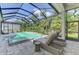 Relaxing pool area with sun loungers, a spillover spa, and a serene backyard view at 9048 Luna Ln, Sarasota, FL 34241