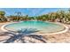 Resort-style community pool featuring lush landscaping, poolside cabanas, and ample lounging space at 9048 Luna Ln, Sarasota, FL 34241