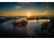 A breathtaking sunset aerial view of waterways, islands, boats, and coastal residences at 976 Euclid Rd, Venice, FL 34293