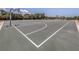 Large outdoor basketball court with multiple hoops and benches surrounded by trees at 976 Euclid Rd, Venice, FL 34293
