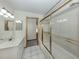 Bathroom featuring walk-in shower with glass doors and a vanity with sink at 976 Euclid Rd, Venice, FL 34293