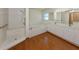 Bright bathroom featuring a garden tub, walk-in shower, and dual sinks at 976 Euclid Rd, Venice, FL 34293