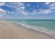 Beautiful beach with clear turquoise water and a sandy shoreline under a bright sky at 976 Euclid Rd, Venice, FL 34293