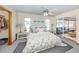Bedroom featuring ceiling fan, large windows, a mirrored closet, and stylish decor at 976 Euclid Rd, Venice, FL 34293