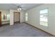 Bedroom featuring a ceiling fan, vanity, and large windows offering ample natural light at 976 Euclid Rd, Venice, FL 34293