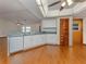 Kitchen featuring white cabinetry, stainless steel appliances, and hardwood floors at 976 Euclid Rd, Venice, FL 34293