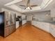 Modern kitchen with stainless steel appliances and hardwood floors, perfect for entertaining at 976 Euclid Rd, Venice, FL 34293