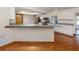 Bright kitchen features white cabinets, stainless steel appliances, and an extended breakfast bar at 976 Euclid Rd, Venice, FL 34293