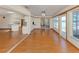 Bright living room featuring wood floors, a ceiling fan, and sliding glass doors at 976 Euclid Rd, Venice, FL 34293