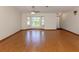 Bright living room with hardwood floors and a large bay window offering plenty of natural light at 976 Euclid Rd, Venice, FL 34293