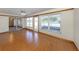 Bright living room featuring wood floors, a ceiling fan, and access to the lanai at 976 Euclid Rd, Venice, FL 34293