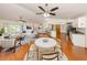 Open-concept living space featuring hardwood floors, kitchen bar, and modern furnishings at 976 Euclid Rd, Venice, FL 34293