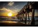 Sunset view of a pier over the ocean with waves and the sky illuminated by the sun at 976 Euclid Rd, Venice, FL 34293
