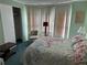 Bedroom featuring a window, seating, closet, bedside table, and floral patterned bedspread at 103 Lakeview Dr, North Port, FL 34287