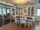 Charming dining room with a wooden table, chandelier, and views of the lanai at 103 Lakeview Dr, North Port, FL 34287