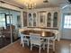 Dining room showcasing dining table with seating, chandelier, display cabinet and sliding glass door at 103 Lakeview Dr, North Port, FL 34287