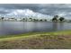 Scenic lake view surrounded by homes and lush greenery under a cloudy sky at 103 Lakeview Dr, North Port, FL 34287