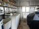 Functional laundry room with washer, dryer, shelving, sink, and window for natural light at 103 Lakeview Dr, North Port, FL 34287