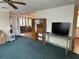 Living room featuring neutral-colored walls, a ceiling fan, furniture, and a decorative bookshelf at 103 Lakeview Dr, North Port, FL 34287