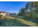 Large backyard featuring a patio, green lawn, and mature trees, offering privacy and ample space at 1032 Elaine St, Venice, FL 34285
