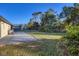 Lush green backyard with mature trees and a patio, perfect for outdoor entertaining and relaxation at 1032 Elaine St, Venice, FL 34285
