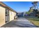 Spacious backyard with a patio, lush green grass, mature trees, and a storage shed in the background at 1032 Elaine St, Venice, FL 34285