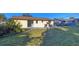 Backyard showcasing a well-maintained lawn and patio, surrounded by mature trees and privacy shrubs at 1032 Elaine St, Venice, FL 34285