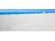 A tranquil beach scene with clear blue water and white sand at 1032 Elaine St, Venice, FL 34285