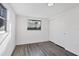 Bedroom featuring gray wood floors, a window providing natural light, and a sliding door closet at 1032 Elaine St, Venice, FL 34285