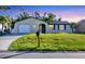 Inviting single-Gathering home with a manicured lawn, lovely blue shutters, and a convenient mailbox at 1032 Elaine St, Venice, FL 34285