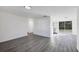 Open-concept living room with new floors and modern lighting, leading into the kitchen and dining area at 1032 Elaine St, Venice, FL 34285