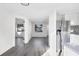 Spacious living room flows into the kitchen, showcasing modern flooring and an open layout at 1032 Elaine St, Venice, FL 34285
