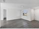Open living area featuring sleek flooring, neutral walls, a new ceiling light, and a street view at 1032 Elaine St, Venice, FL 34285