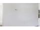 Image of a wall painted white, featuring a thermostat and an electrical outlet at 1032 Elaine St, Venice, FL 34285
