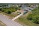 Aerial view of a charming single-Gathering home with a long driveway and surrounded by lush landscaping at 10444 Willmington Blvd, Englewood, FL 34224