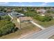Aerial view of a single-Gathering home featuring a well-manicured lawn and a peaceful neighborhood setting at 10444 Willmington Blvd, Englewood, FL 34224