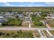 Aerial view shows a home nestled in a quiet neighborhood surrounded by trees and other well-maintained properties at 10444 Willmington Blvd, Englewood, FL 34224