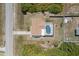 Aerial view of a home with a screened-in pool and well-maintained yard in a sunny neighborhood at 10444 Willmington Blvd, Englewood, FL 34224