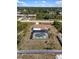 An aerial view showcases the home with a screened-in pool and an enclosed backyard for added privacy at 10444 Willmington Blvd, Englewood, FL 34224