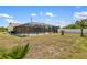 A long backyard with a screened-in pool and AC equipment at 10444 Willmington Blvd, Englewood, FL 34224