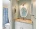 Bathroom features granite countertop, white cabinets, and coordinated decor at 10444 Willmington Blvd, Englewood, FL 34224